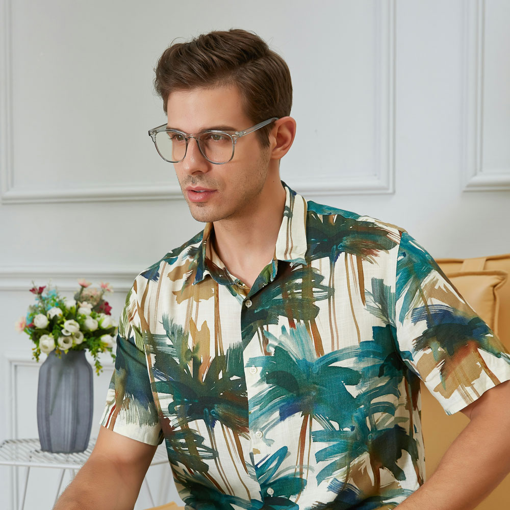 Un uomo che indossa occhiali da vista e una maglietta con stampa tropicale. - Crisafulli Eyewear a Milano